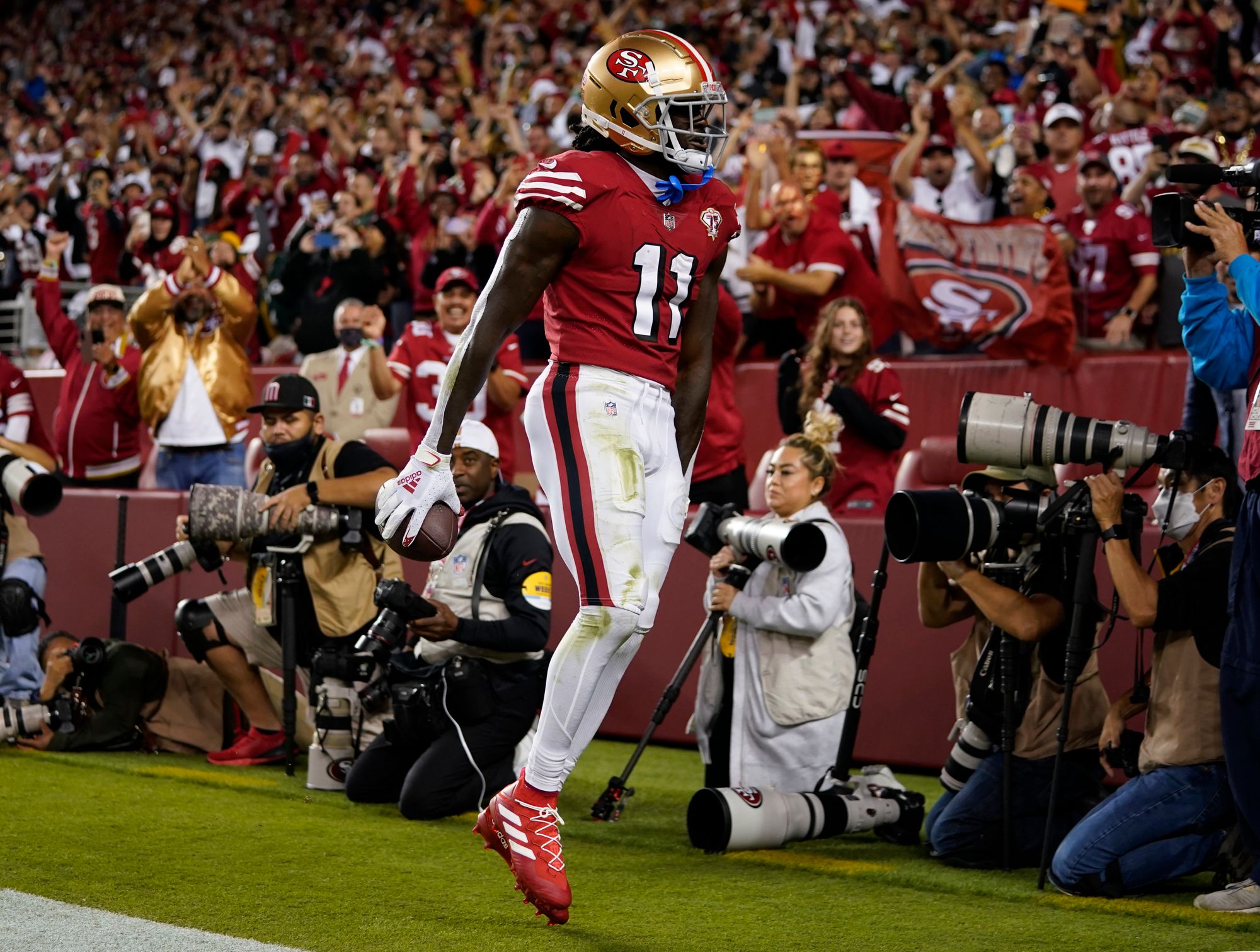 Brandon Aiyuk #11 of the San Francisco 49ers celebrates after catching a to...